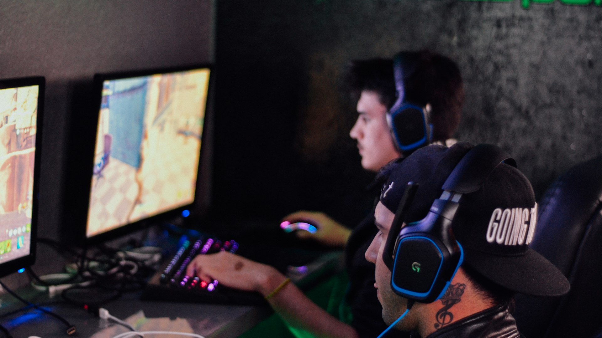 Players gathered around glowing screens during a late-night raid session